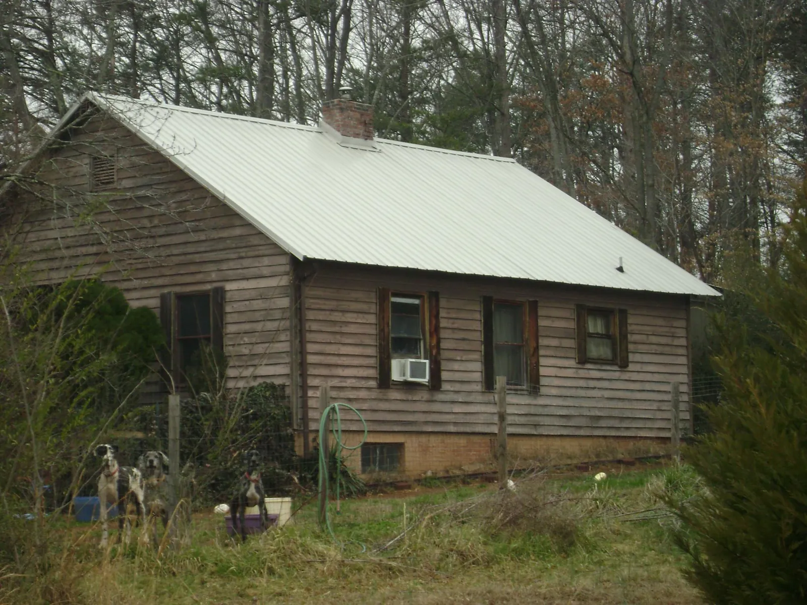 White metal roof on an old wood sided farmhouse, from a Metal Roof Installation job in Millersville